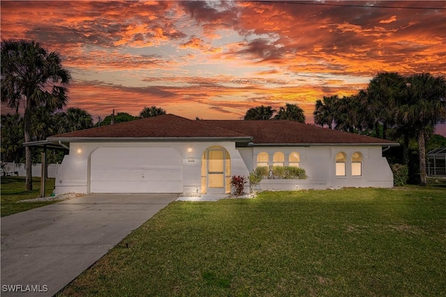 mediterranean / spanish-style house with a garage and a lawn