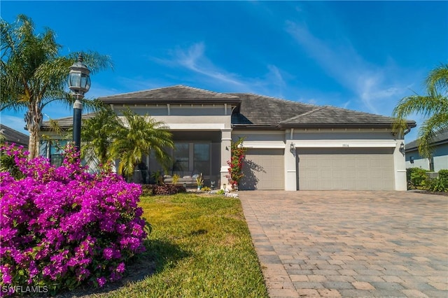 view of front of property featuring a garage and a front lawn