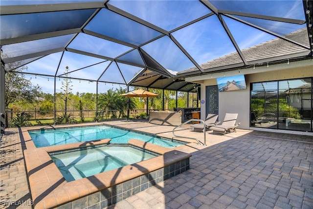 view of pool featuring a lanai, a patio, and an in ground hot tub