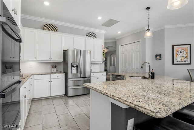 kitchen featuring appliances with stainless steel finishes, sink, white cabinets, hanging light fixtures, and a spacious island