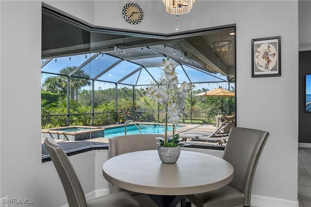 view of patio / terrace with a lanai and a pool with hot tub