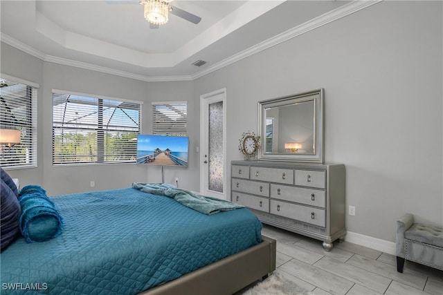 bedroom featuring ceiling fan, ornamental molding, and a raised ceiling