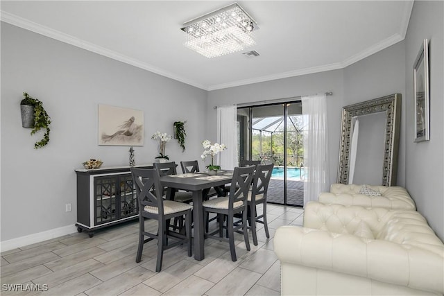 dining room with crown molding and an inviting chandelier