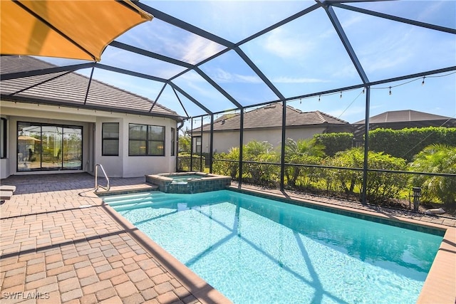 view of swimming pool with a patio, glass enclosure, and an in ground hot tub