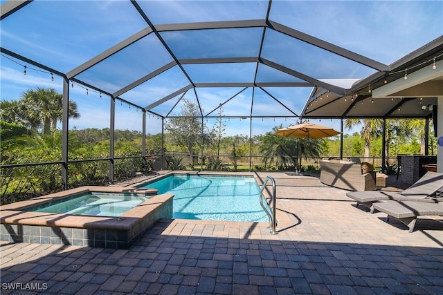 view of pool featuring an in ground hot tub, glass enclosure, and a patio