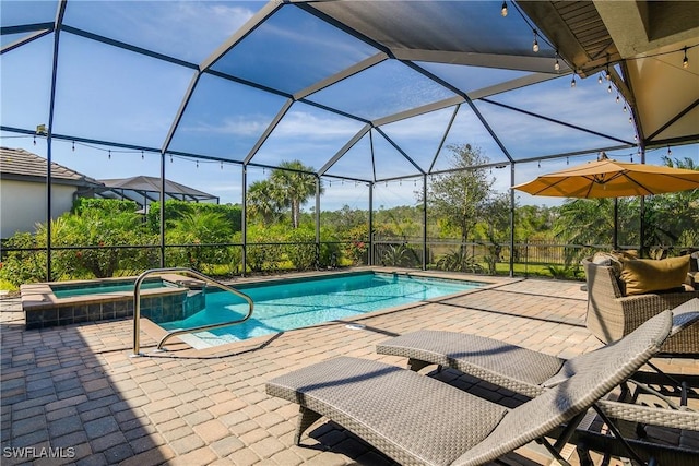 view of pool featuring an in ground hot tub, glass enclosure, and a patio area