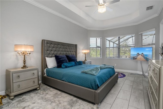 bedroom featuring ornamental molding, light tile patterned flooring, ceiling fan, and a tray ceiling