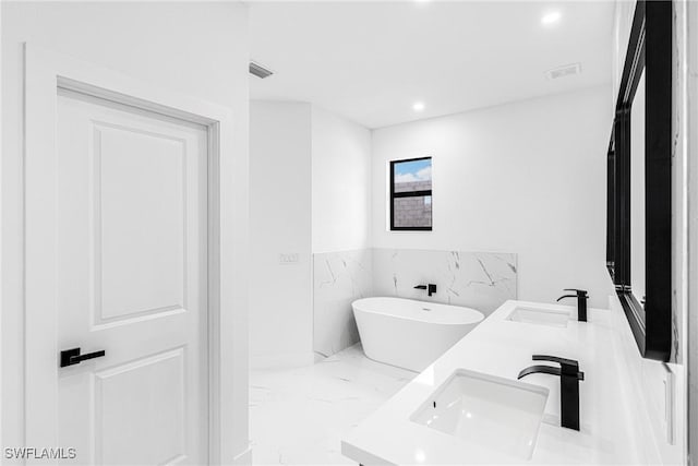 bathroom with vanity and a bathing tub