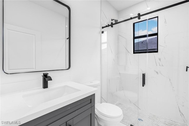 bathroom featuring an enclosed shower, vanity, and toilet