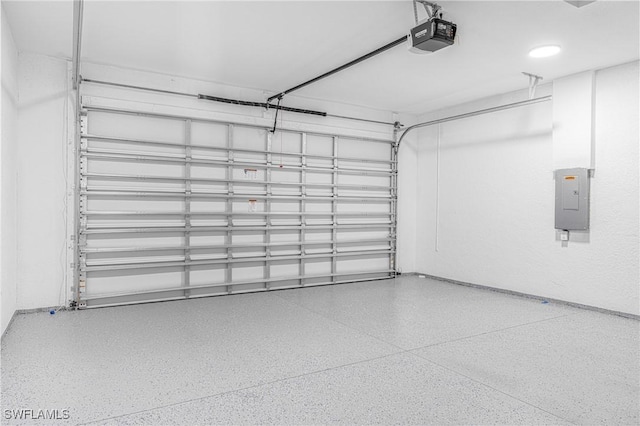 garage with a garage door opener and electric panel