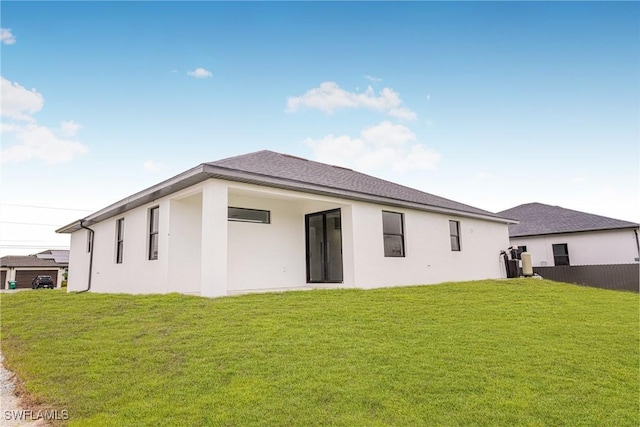 rear view of house with a yard