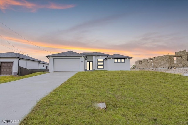 view of front of property featuring a garage and a yard