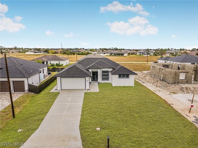 view of front of home featuring a garage and a front lawn