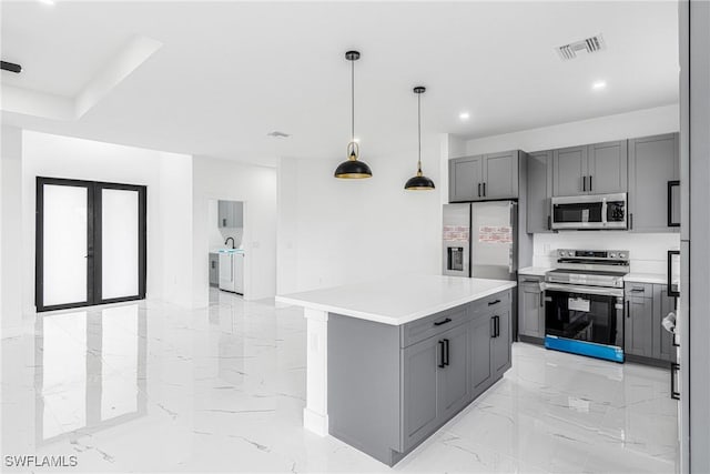 kitchen featuring stainless steel appliances, pendant lighting, a center island, and gray cabinetry