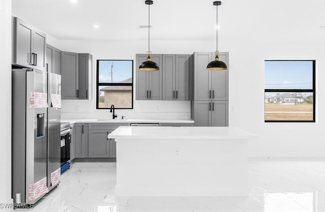 kitchen featuring electric stove, gray cabinets, stainless steel fridge with ice dispenser, and hanging light fixtures