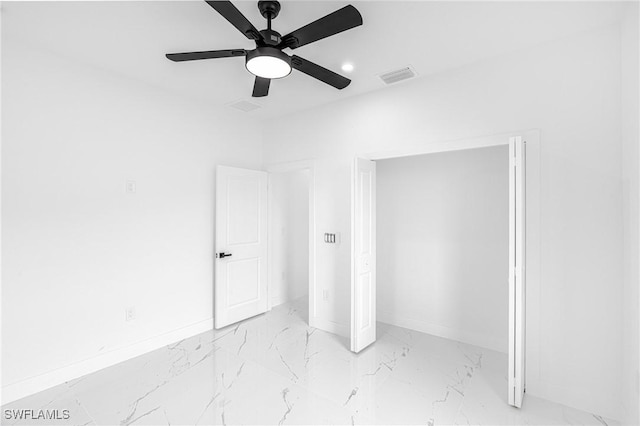 unfurnished bedroom with ceiling fan and a closet