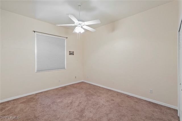 unfurnished room featuring baseboards, carpet floors, and a ceiling fan