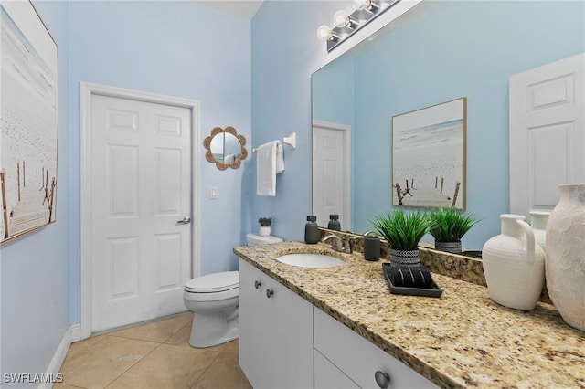 bathroom featuring vanity, tile patterned floors, toilet, and baseboards