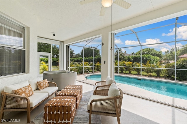 sunroom / solarium featuring a pool and a ceiling fan