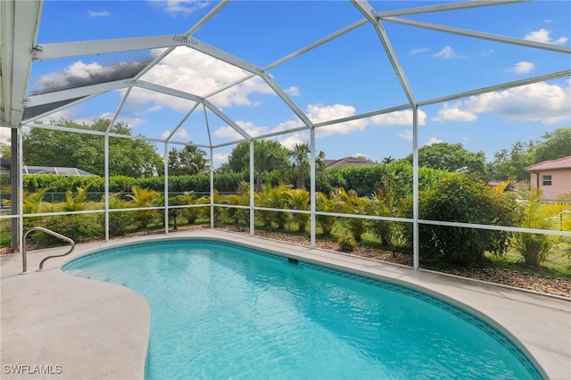 pool with a lanai and a patio area