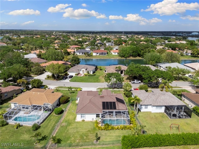 drone / aerial view with a residential view and a water view