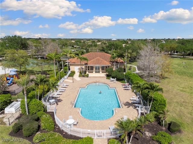 community pool featuring a patio area and fence