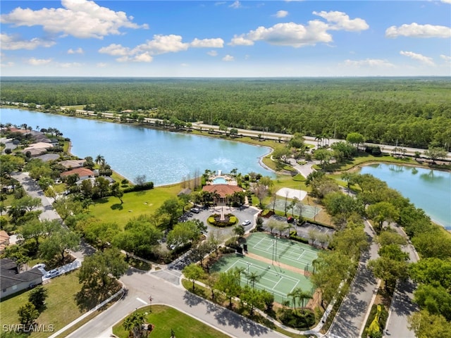 birds eye view of property featuring a forest view and a water view