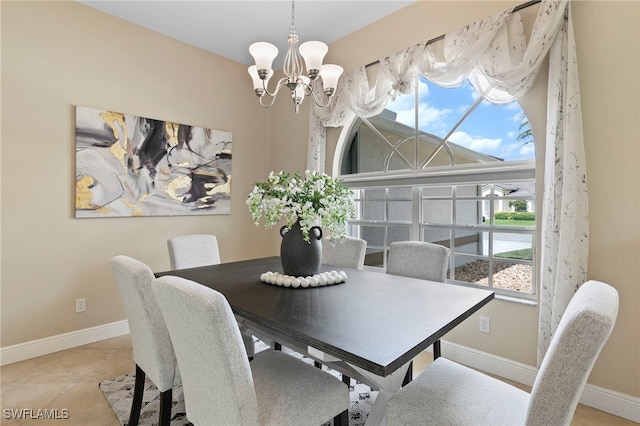 tiled dining room with a notable chandelier, baseboards, and plenty of natural light