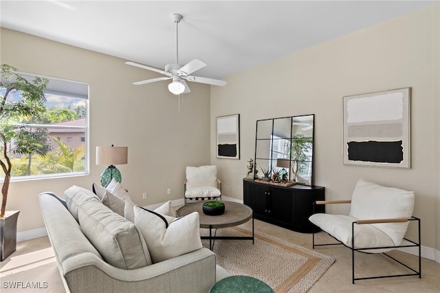 living area with plenty of natural light, baseboards, and ceiling fan