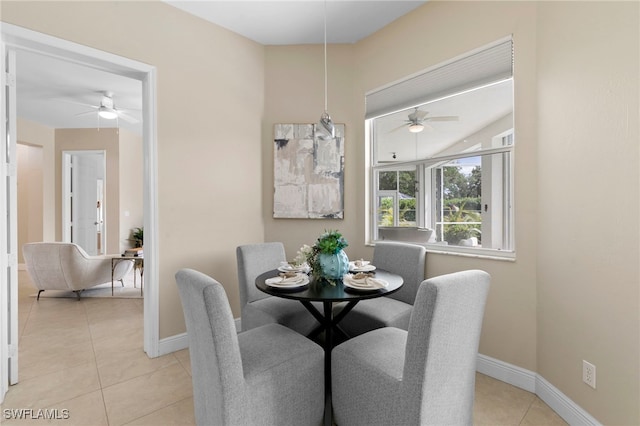 dining area with light tile patterned floors, baseboards, and ceiling fan