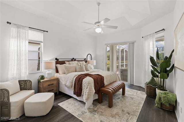 bedroom featuring ceiling fan, dark wood-type flooring, and access to exterior