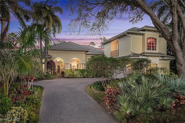 mediterranean / spanish-style house with a garage