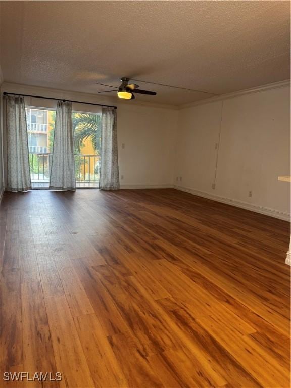 unfurnished room with baseboards, a ceiling fan, wood finished floors, crown molding, and a textured ceiling