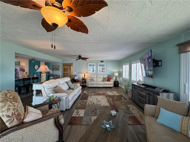 living room featuring dark hardwood / wood-style floors and a textured ceiling