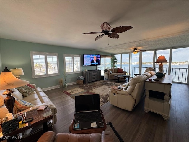 living room with dark hardwood / wood-style flooring and ceiling fan