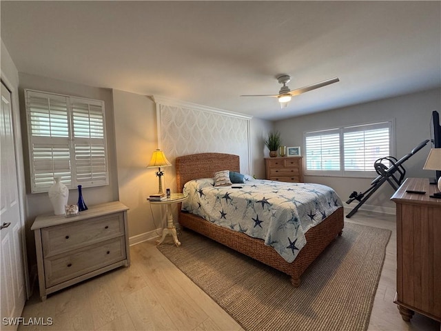 bedroom with ceiling fan and light hardwood / wood-style floors