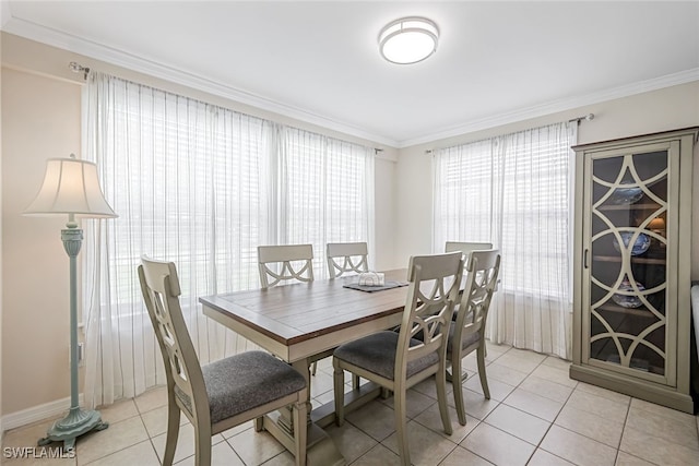 dining area with crown molding and light tile patterned flooring