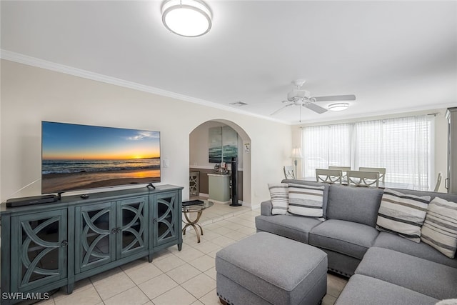 tiled living room with crown molding and ceiling fan