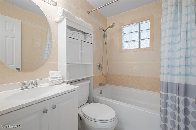 full bathroom with shower / bath combo, vanity, and toilet