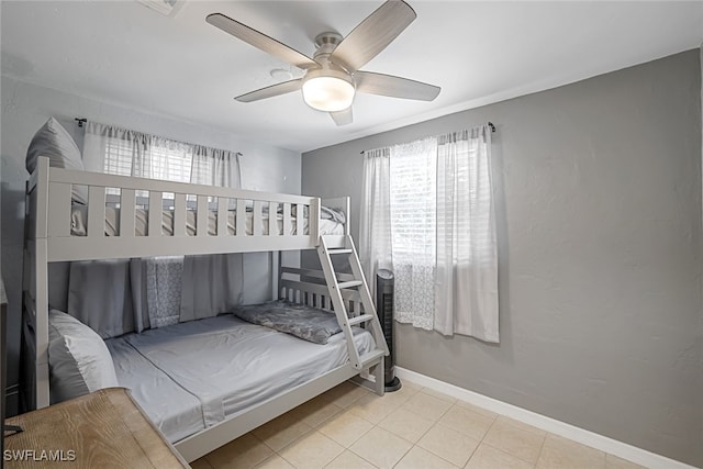 bedroom with light tile patterned floors and ceiling fan