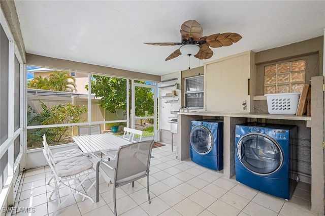 laundry room with ceiling fan, independent washer and dryer, and light tile patterned flooring