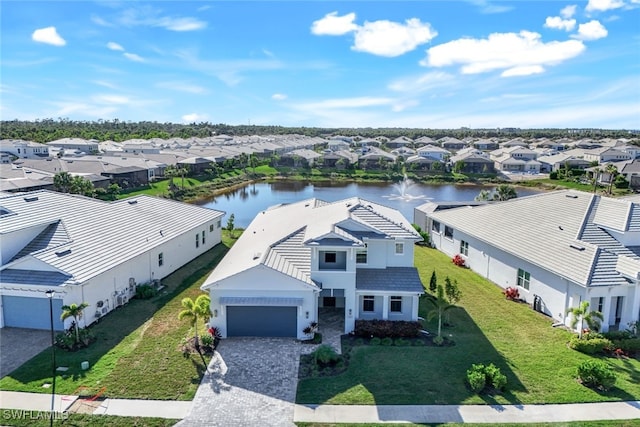 birds eye view of property with a residential view and a water view