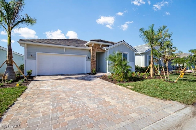 ranch-style house with a garage and a front lawn