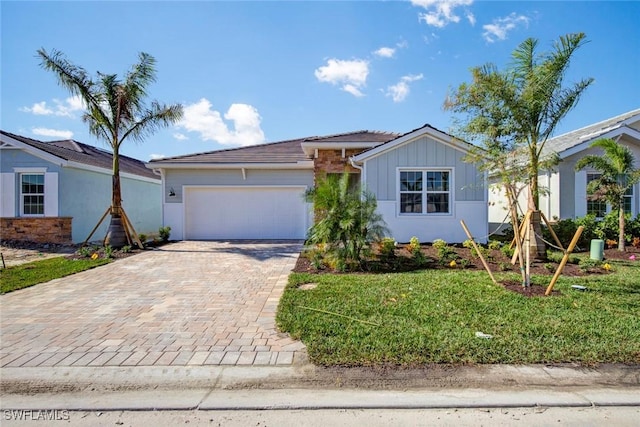 view of front of property with a garage and a front lawn