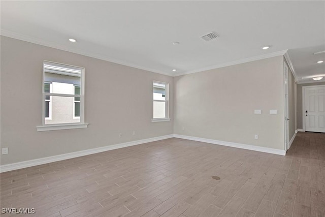 unfurnished room with light hardwood / wood-style flooring and ornamental molding