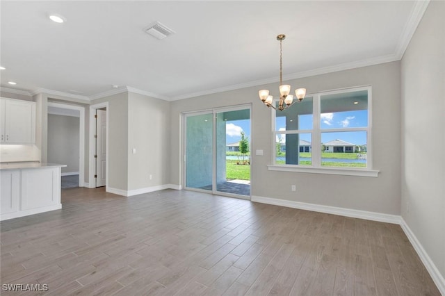 interior space featuring crown molding, light hardwood / wood-style floors, and a notable chandelier