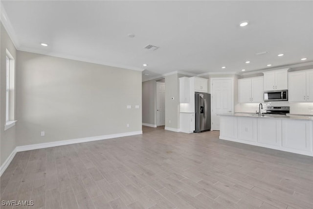 kitchen featuring ornamental molding, light hardwood / wood-style flooring, stainless steel appliances, and white cabinets