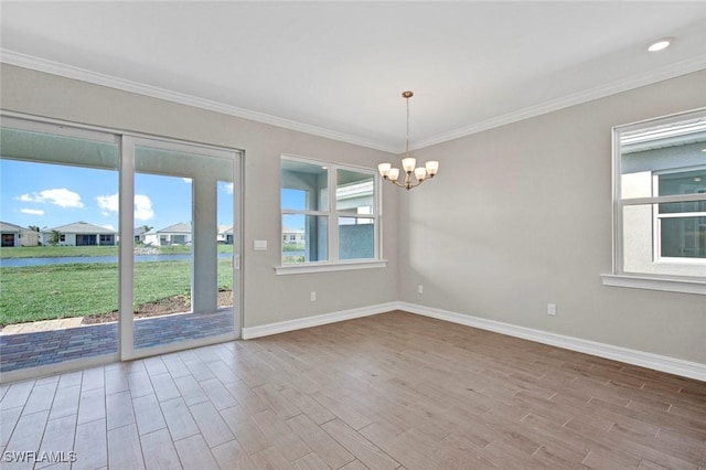 empty room with a notable chandelier, hardwood / wood-style flooring, and ornamental molding