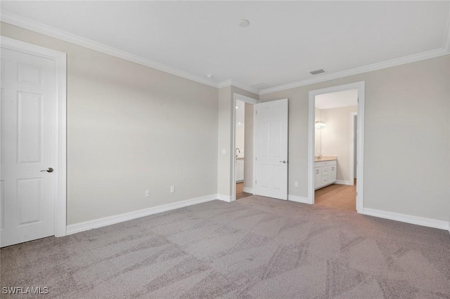 unfurnished bedroom with ornamental molding, connected bathroom, and light carpet