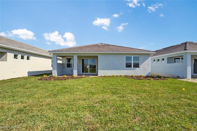 rear view of house with a yard